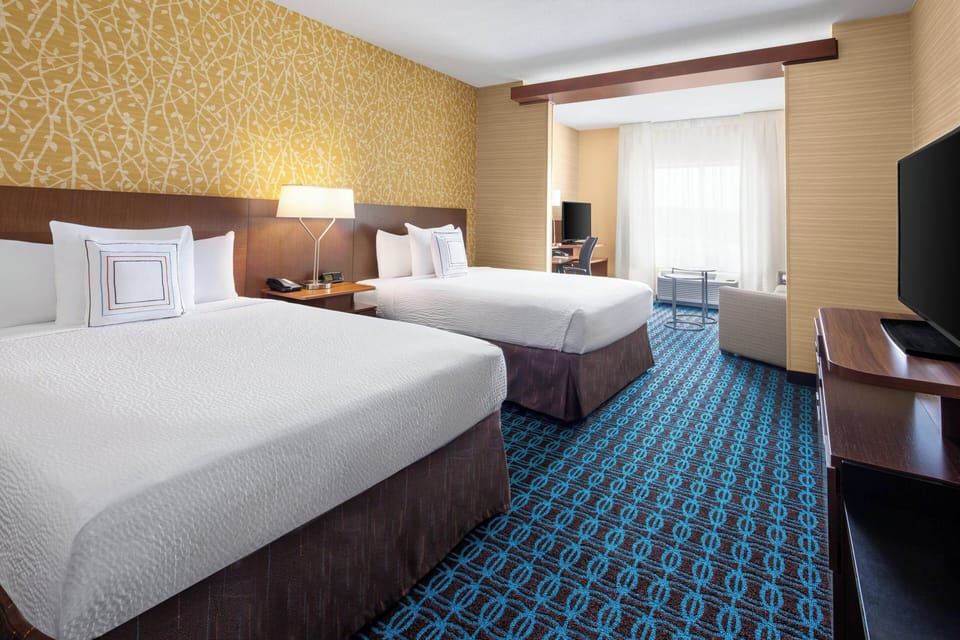 Hypo-allergenic bedding, desk, laptop workspace, blackout drapes