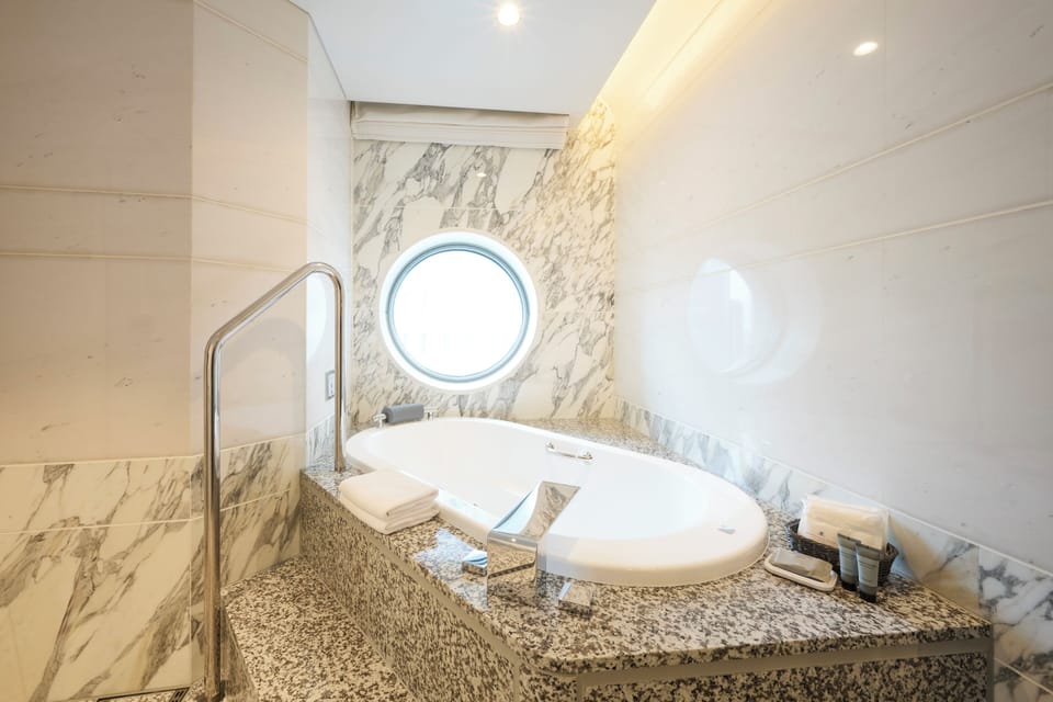 Suite, Non Smoking | Bathroom | Separate tub and shower, hydromassage showerhead, free toiletries