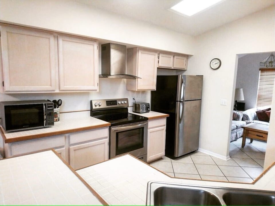 Fully equipped kitchen featuring sleek stainless steel appliances.