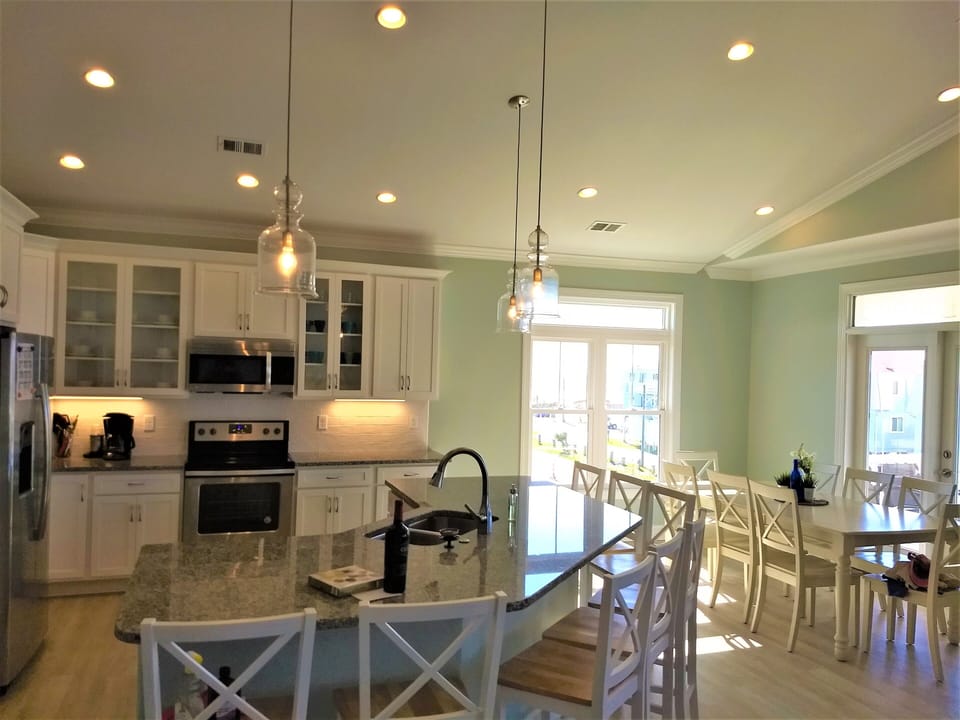 Kitchen with large island with 8 seats.  Another 8 seats at dining table