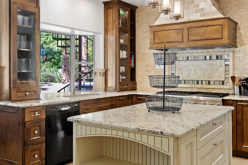 Fully-stocked kitchen with backyard views. Set up some snacks and drinks to share