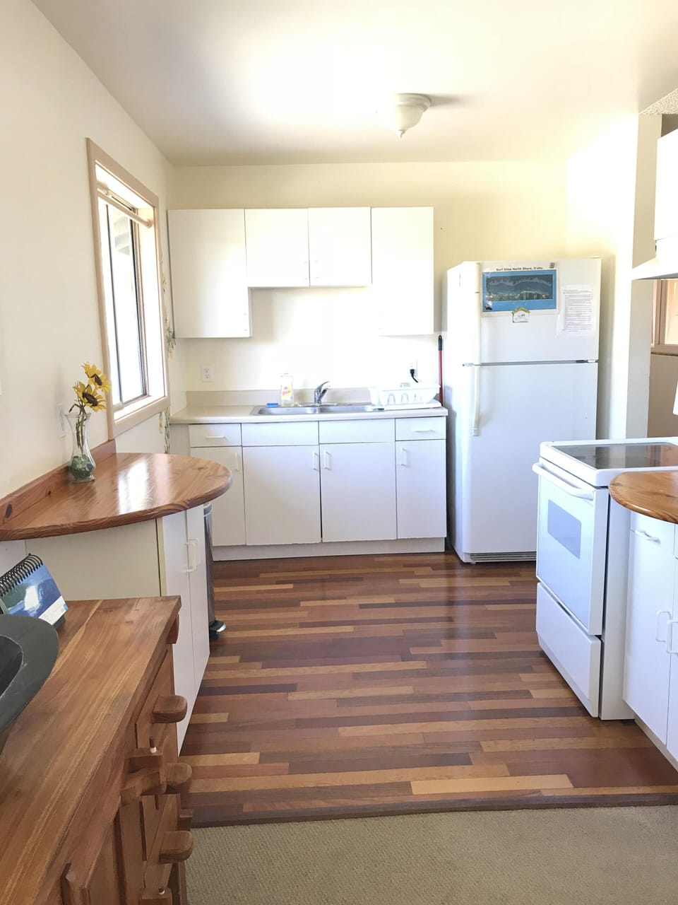 Fully equipped kitchen with custom wood floors full size fridge & oven/stove 