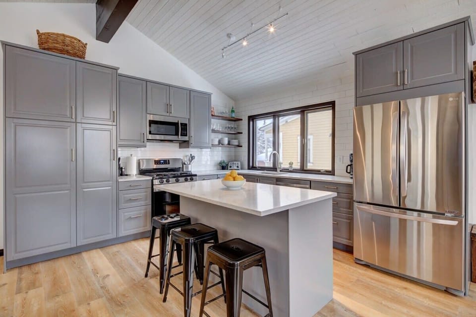 The kitchen is fully-equipped with stainless steel appliances and breakfast bar seating