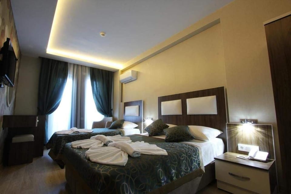 Standard Triple Room | Minibar, in-room safe, desk, soundproofing