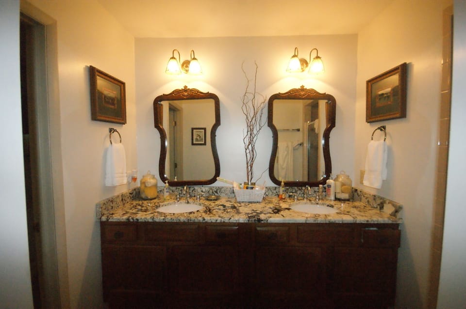 Upstairs master with two sinks,  to toliets to the he left, shower to the right