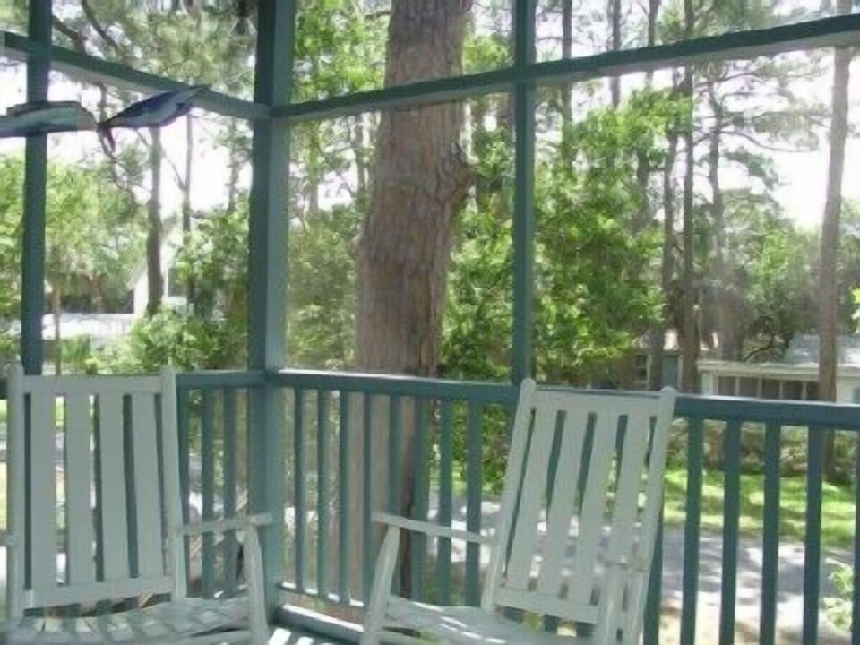 Enjoy the ocean breeze while rocking on the screened in porch. 