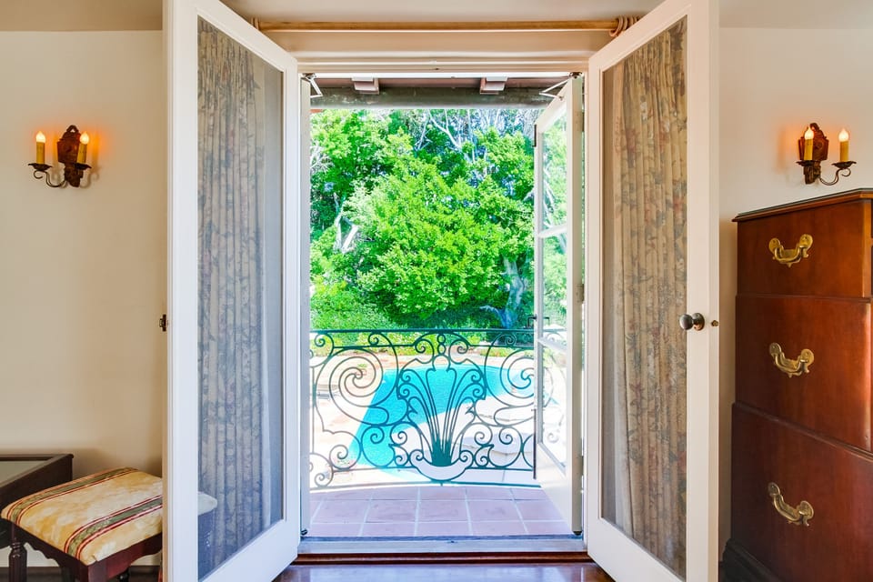View down to pool, looking through iron balcony,  from Master Bedroom.