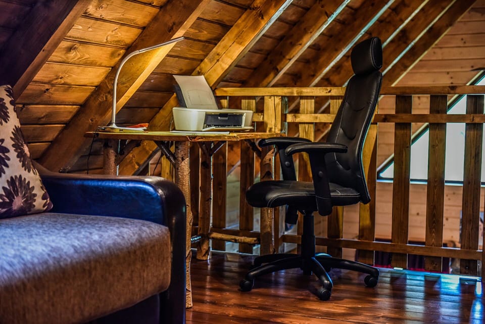 The office in the upstairs loft, with a skylight and balcony.
