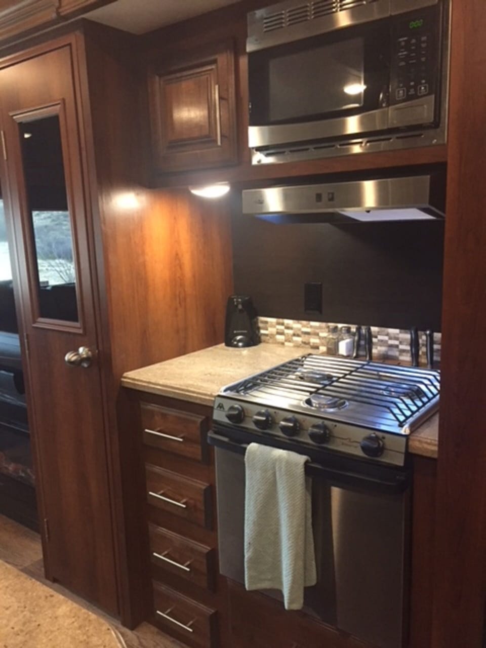 Nice range/oven with microwave, elect can-opener and seasonings cabinet.