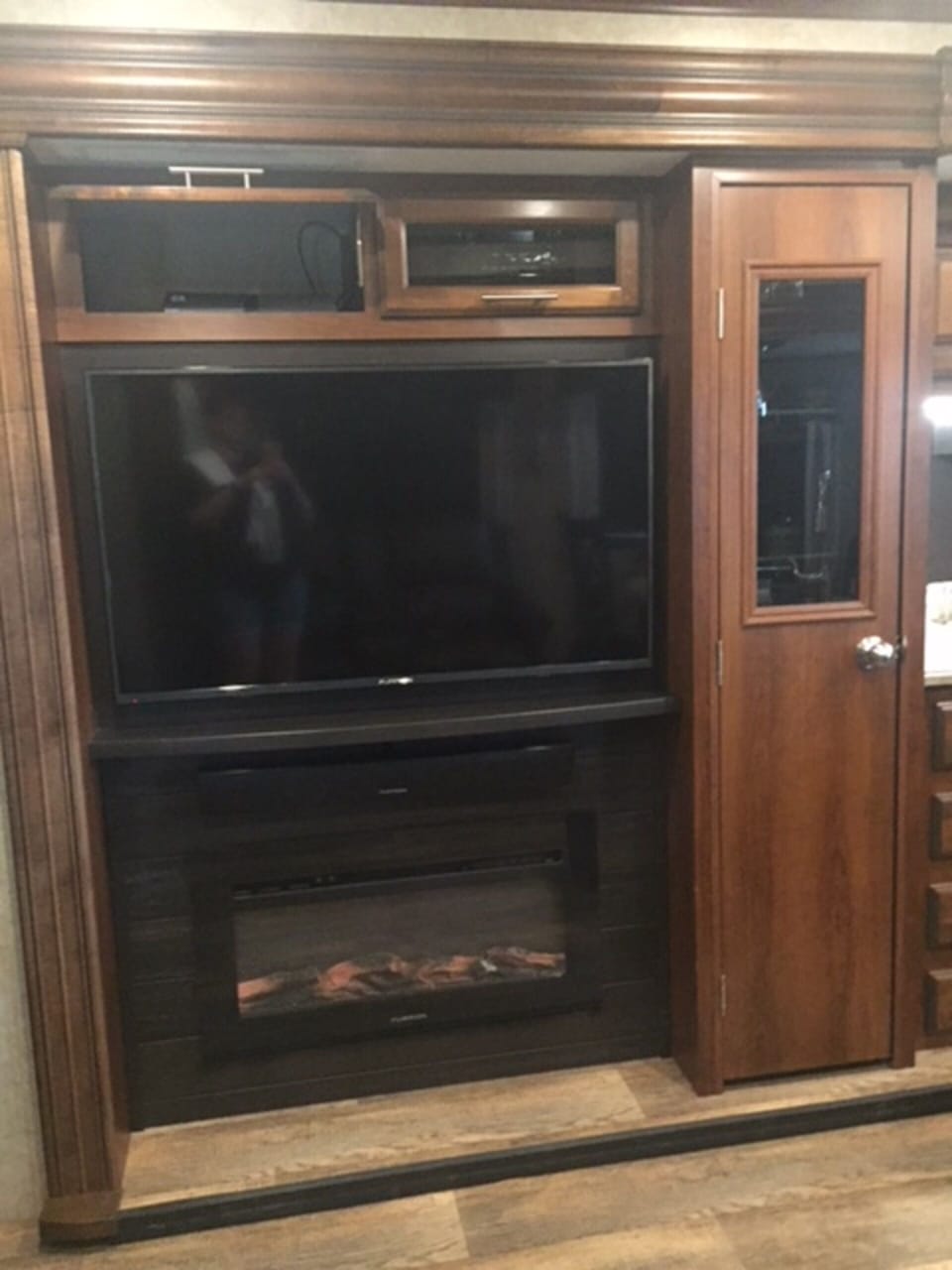 Stereo and DVR upper cabinet, large flat screen and elect romantic fireplace.