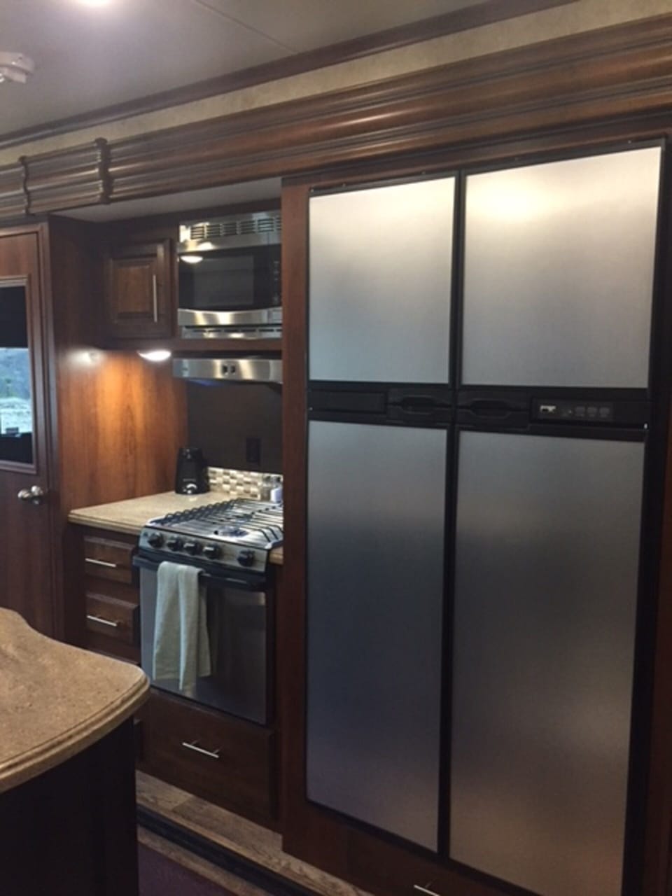 Lots of freezer and frig space in a well lit kitchen.