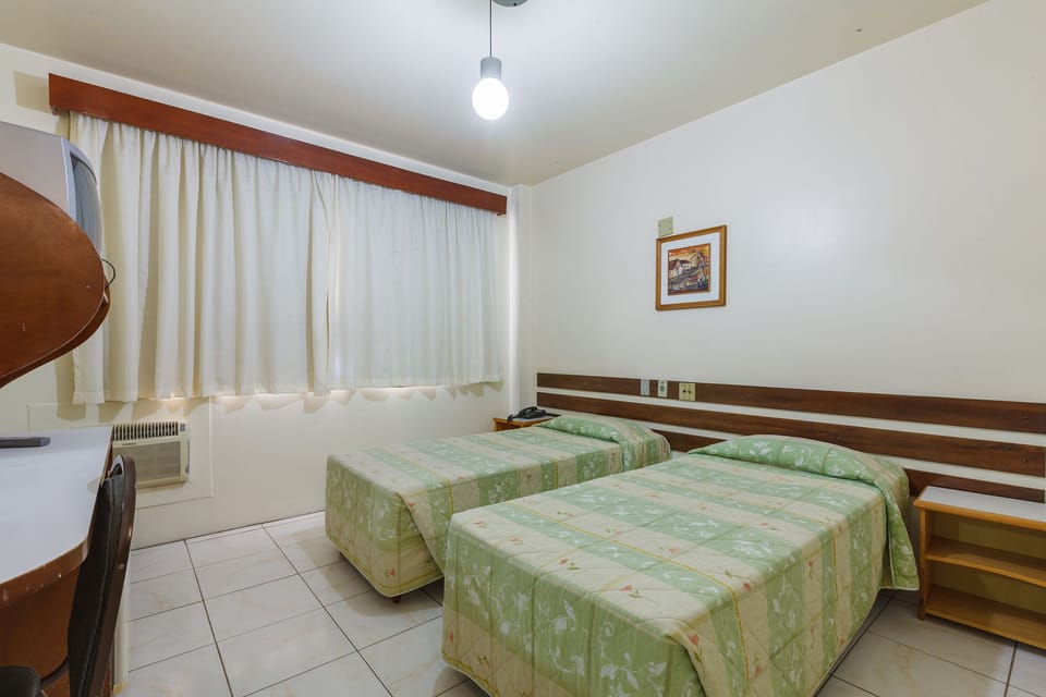 Deluxe Twin Room | Minibar, desk, laptop workspace, iron/ironing board