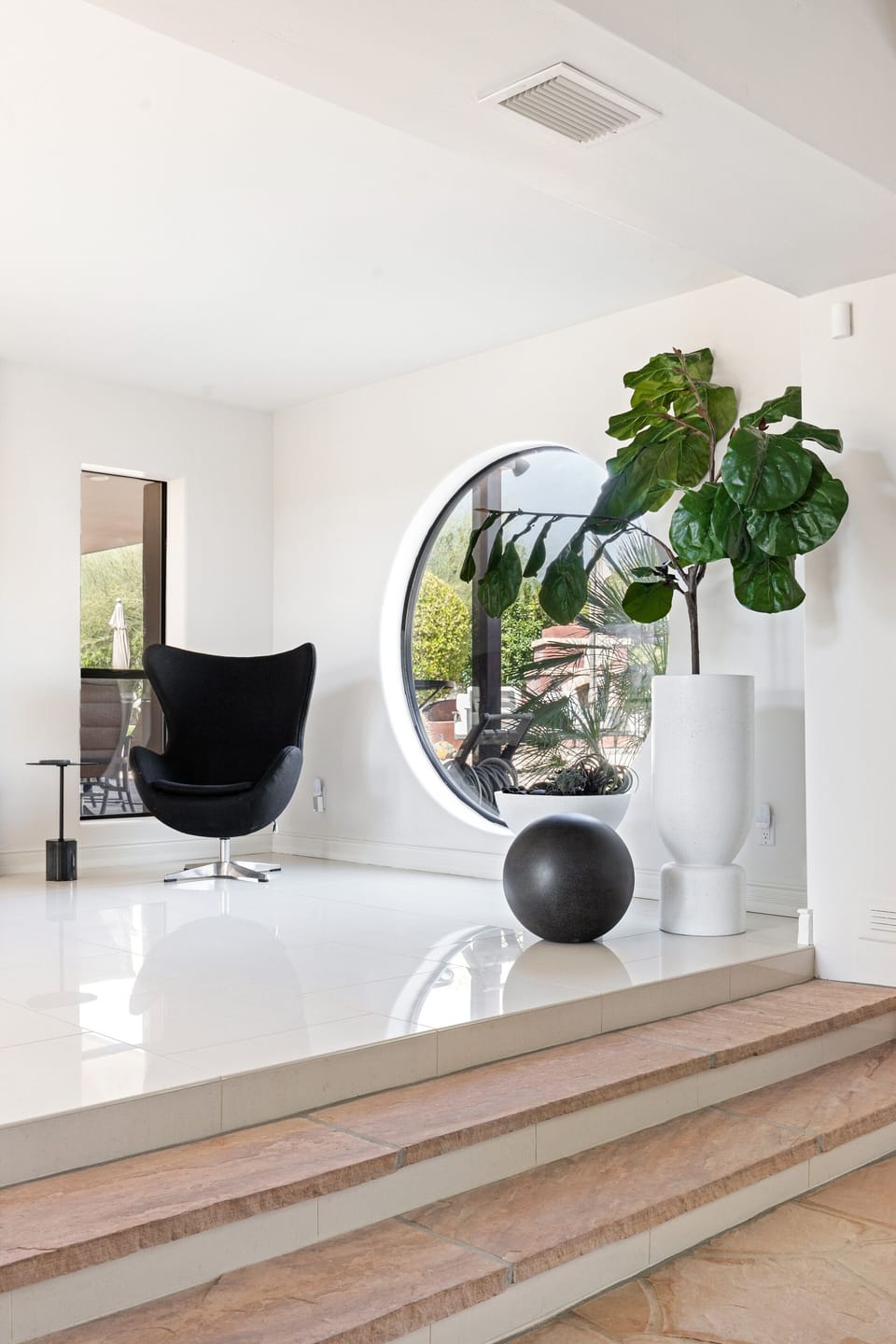 Jacobsen egg chair in entry hall. Steps down to grand salon. 