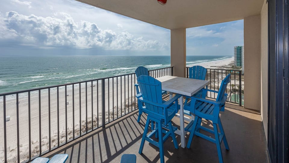 Relax at the outdoor patio set, enjoying views of the waves and beach from your elevated balcony