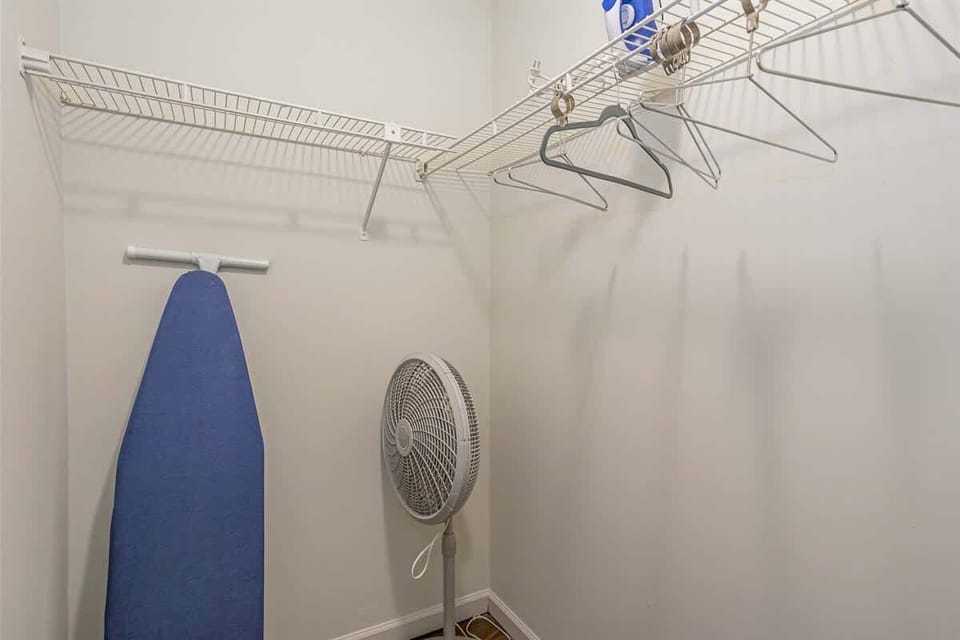 A handy storage space with an ironing board and fan, adding everyday convenience to your stay.