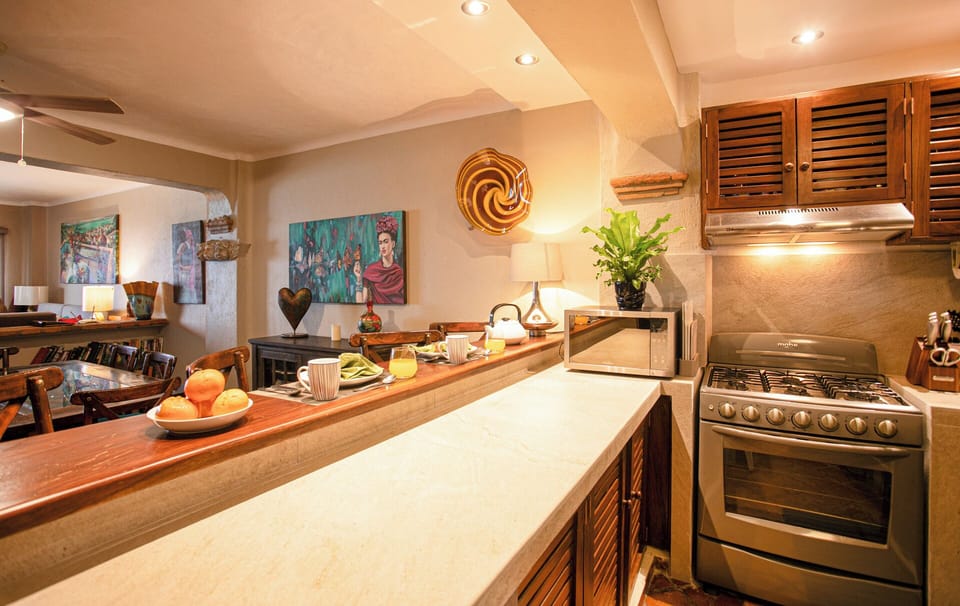 REMODELED KITCHEN WITH NEW COUNTERS, BAR, SINK AND LIGHTING 