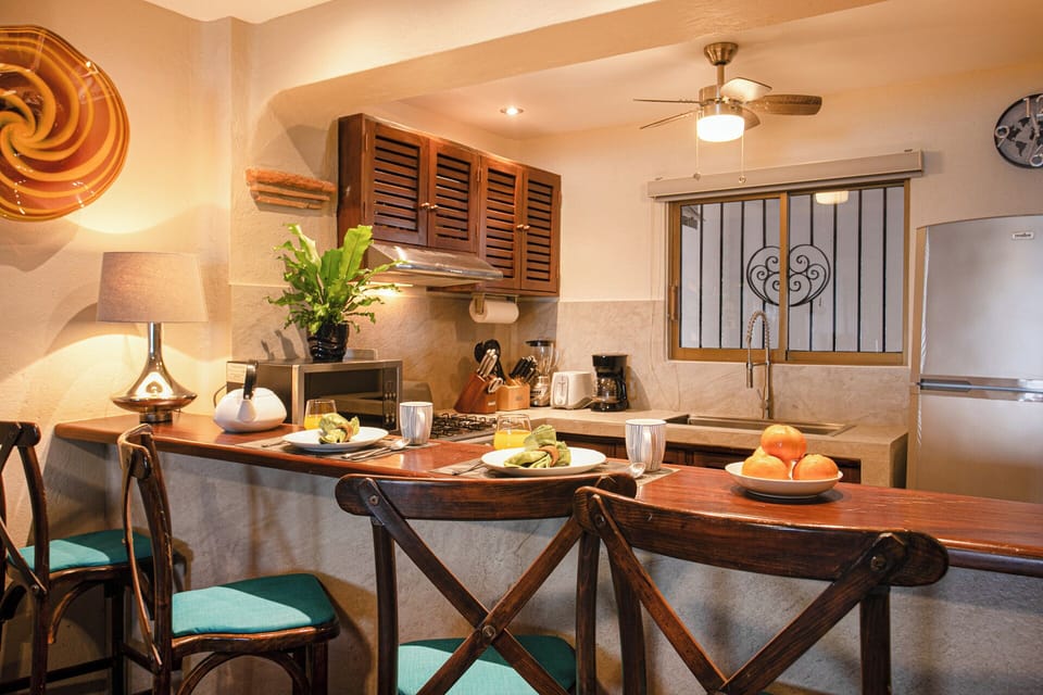 REMODELED KITCHEN WITH NEW COUNTERS, BAR, SINK AND LIGHTING 