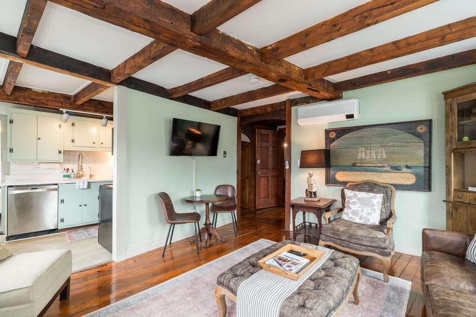 Living Room: Timber beams and a blend of vintage charm invite relaxation and great conversations!