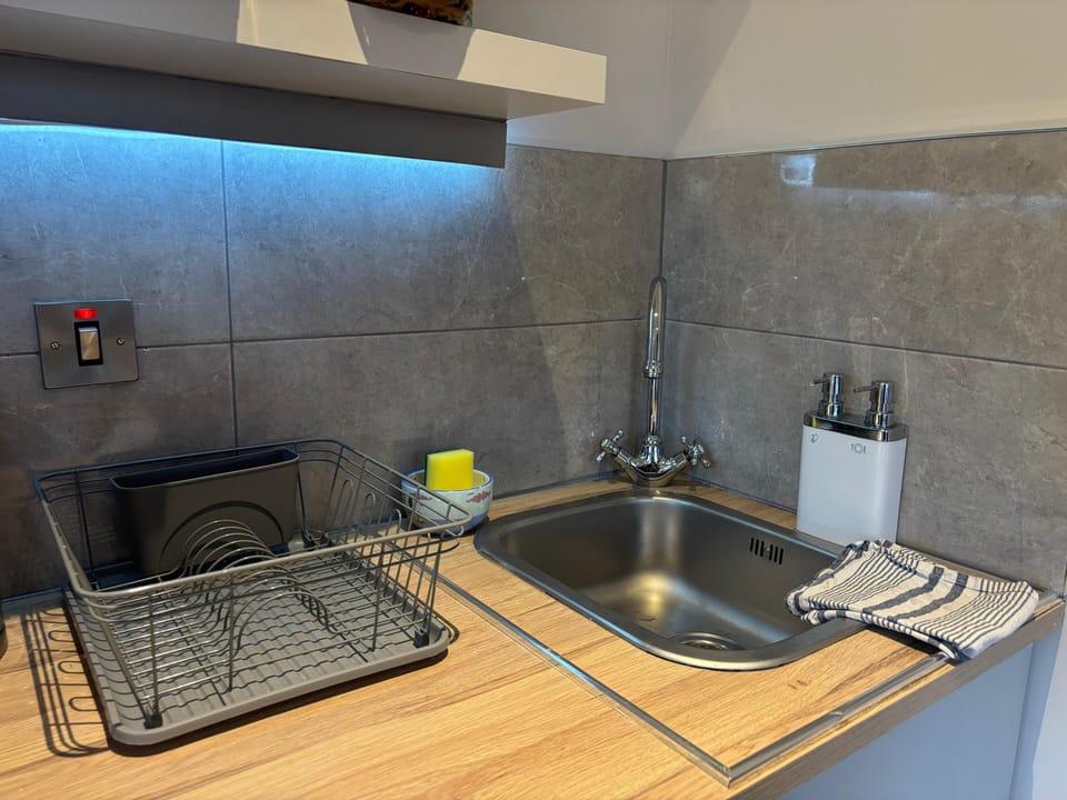 Superior Cottage, 1 King Bed, Non Smoking, Garden Area | Private kitchenette | Cleaning supplies, dining tables