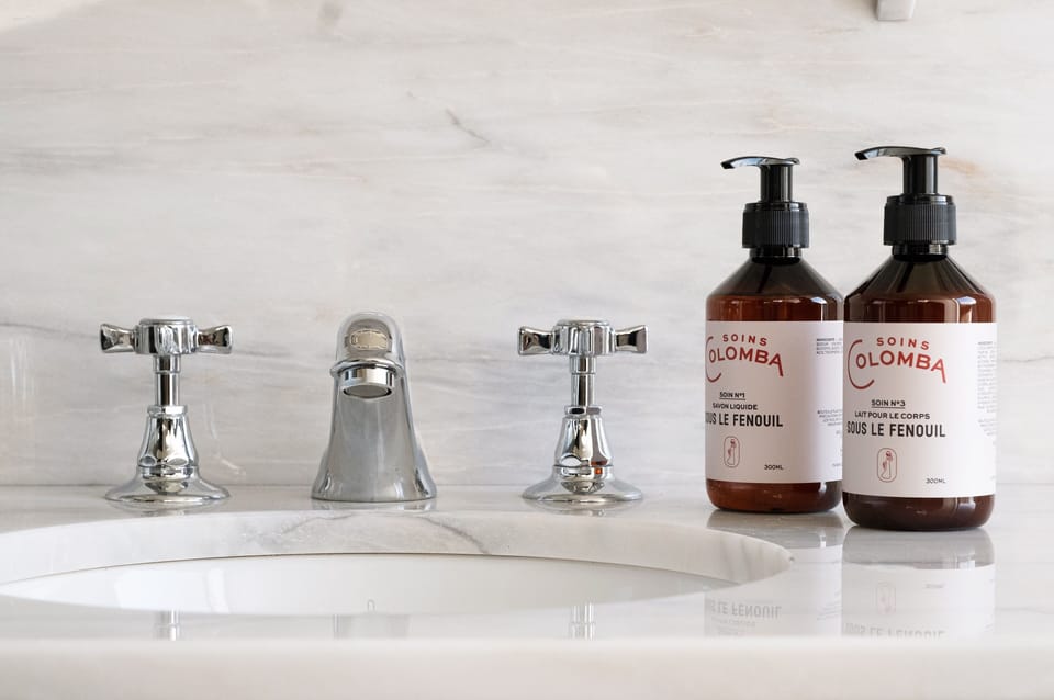 Eco-friendly toiletries, hair dryer, slippers, towels