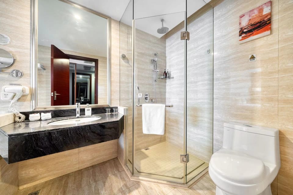 Separate tub and shower, hair dryer, slippers, towels