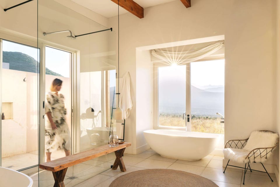 Separate tub and shower, rainfall showerhead, designer toiletries