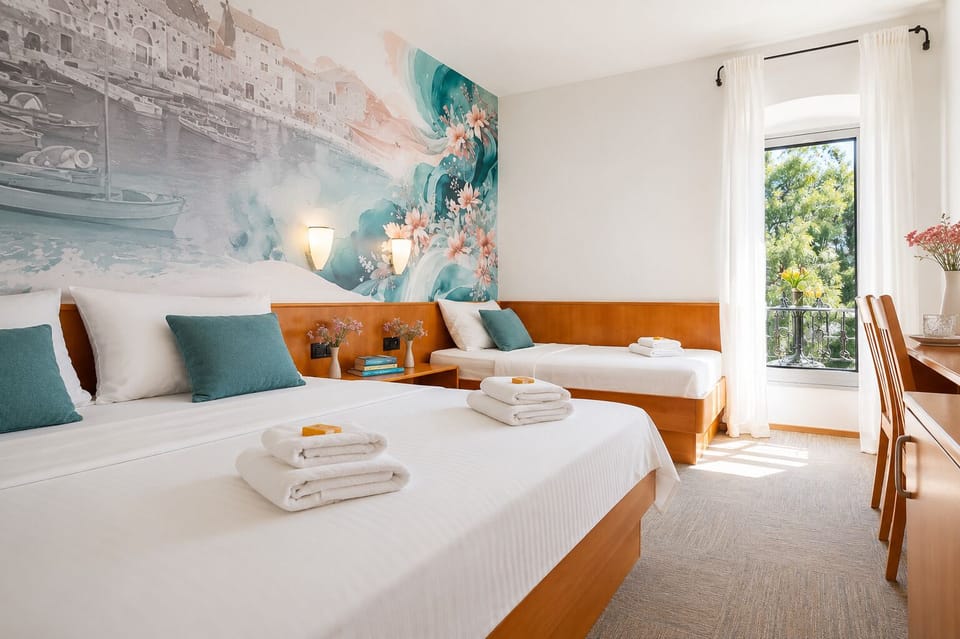 Standard Triple Room, Balcony, Partial Sea View | In-room safe, desk, free cribs/infant beds, free WiFi