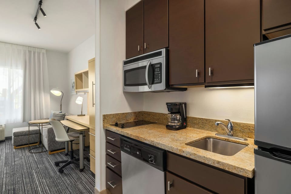 Studio, 1 King Bed | Private kitchen | Full-size fridge, microwave, stovetop, dishwasher