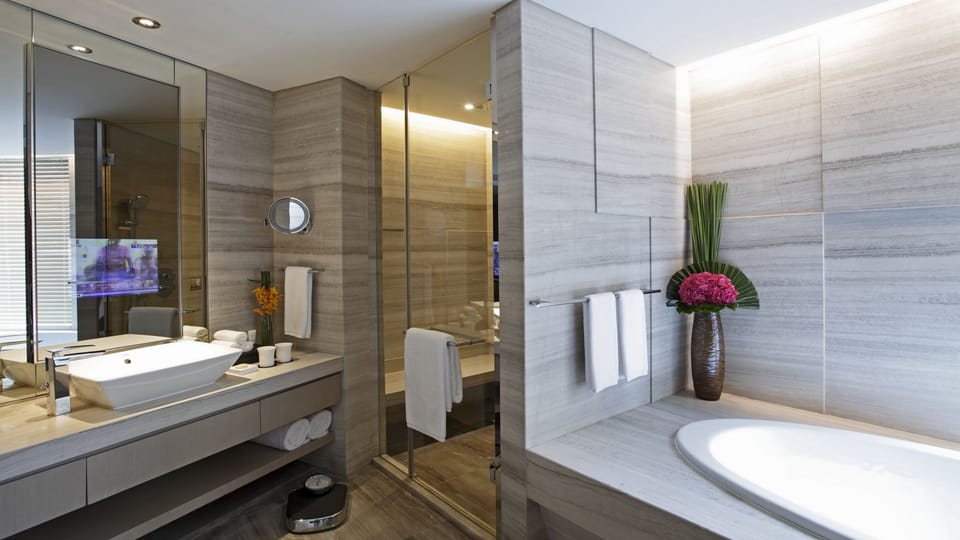 Separate tub and shower, hydromassage showerhead, designer toiletries