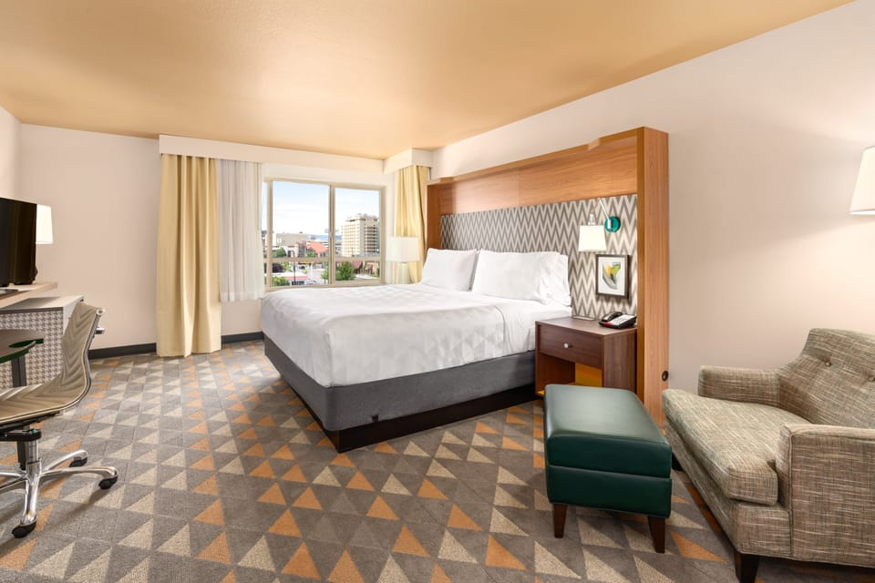 Premium bedding, desk, laptop workspace, blackout drapes