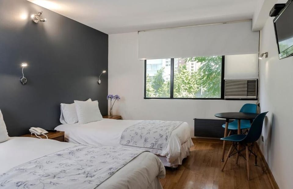 Twin Room | Minibar, in-room safe, individually decorated, individually furnished