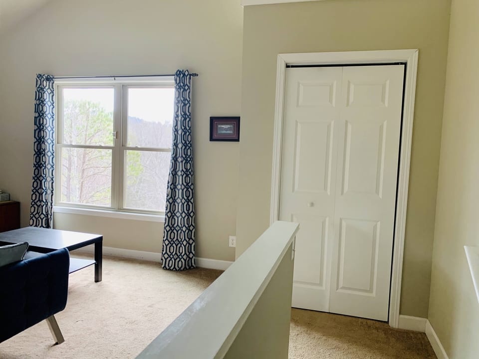 Stairs lead to the sitting area. Great large window to view the mountains