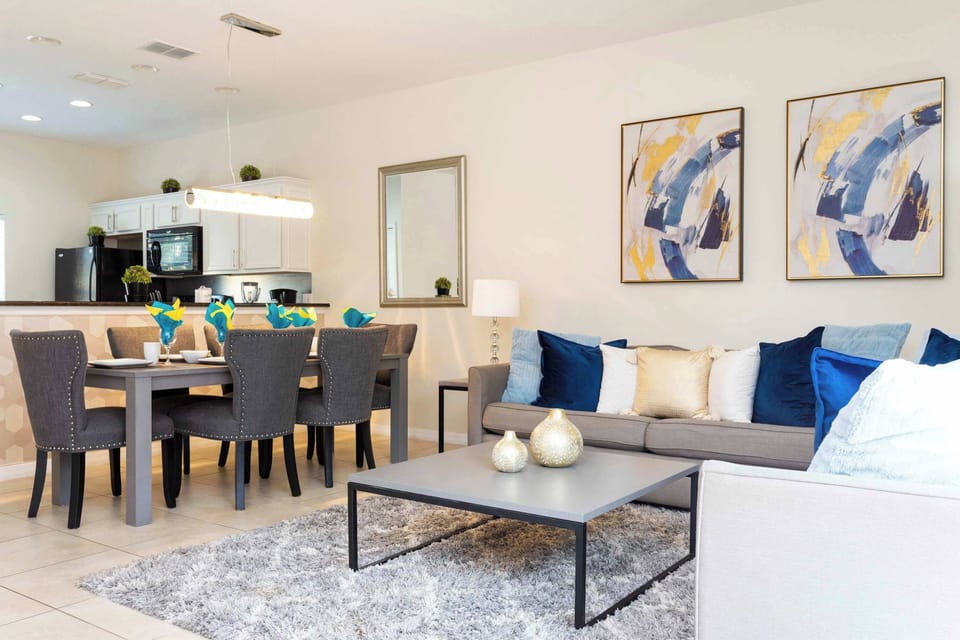 Elegant Living Area with TV & Patio Access: Relax in a sophisticated living room designed for entertainment and comfort, with direct patio access for seamless indoor-outdoor living.
