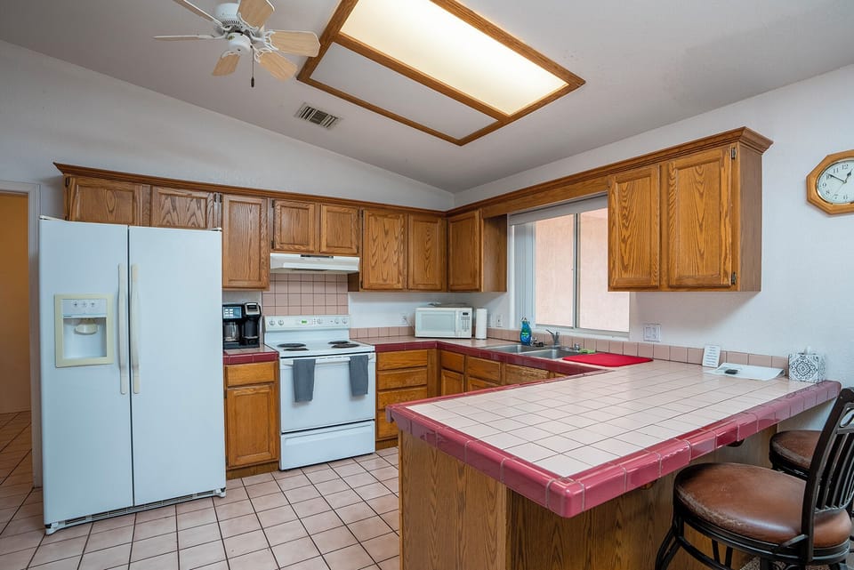 Convenient open kitchen with all the amenities... includes breakfast bar, chairs