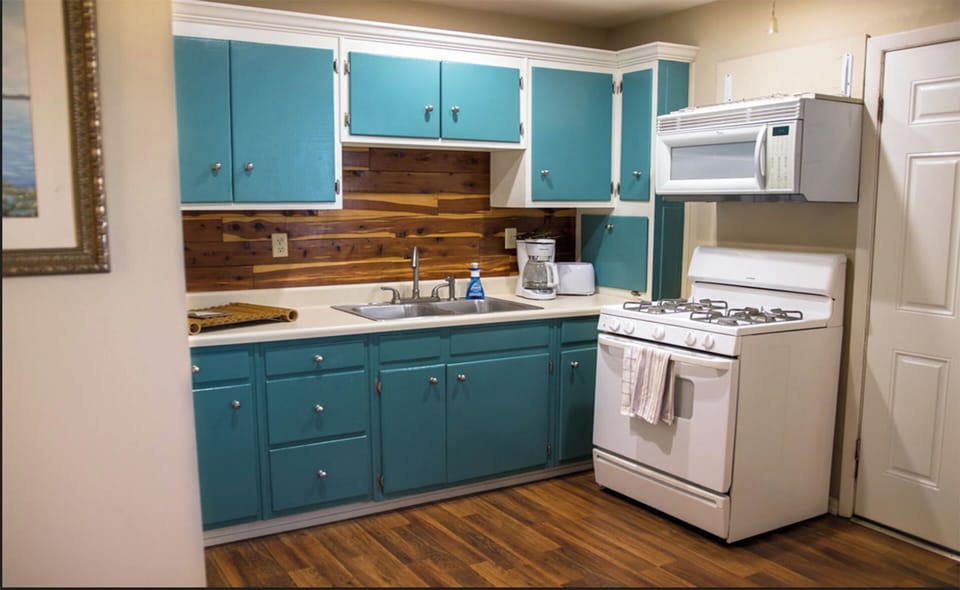 Full size kitchen. It also has a full fridge to the left of the cabinets.