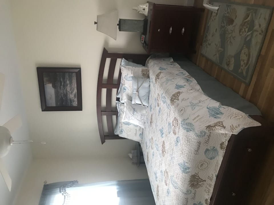 Queen Bed with flat screen tv on wall
