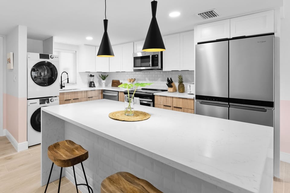 Sleek modern kitchen with elegant lighting and a spacious island for dining