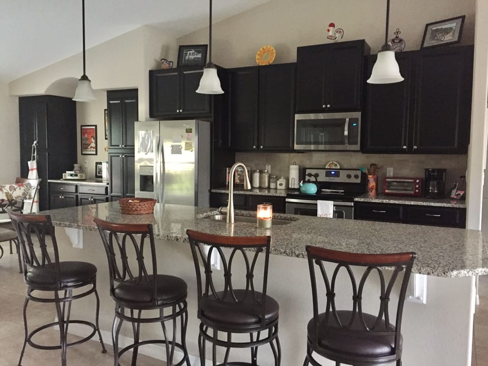 Kitchen w/lots of space, seating, and everything one needs to prepare meals.