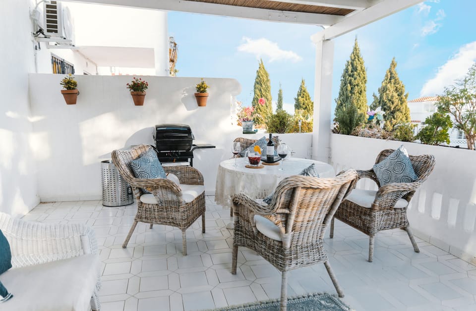 Barbecue and dining table outside on the terrace