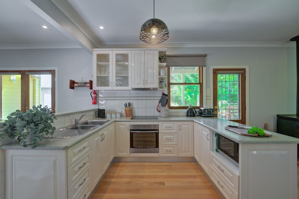 Modern kitchen with extensive cookware and appliances.
