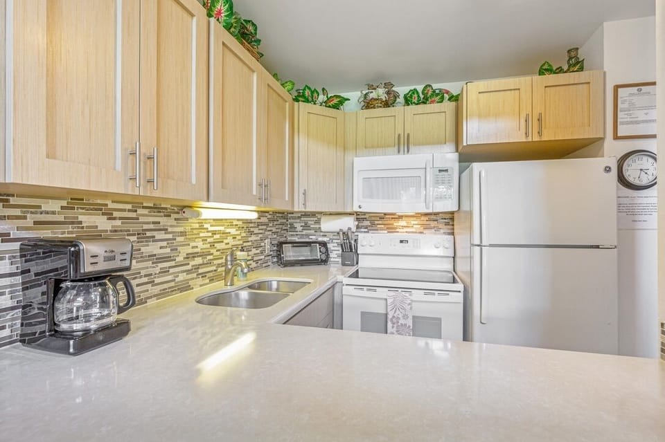 Cook your favorite meals in this bright, fully-equipped kitchen with modern appliances and beautiful tile backsplash.