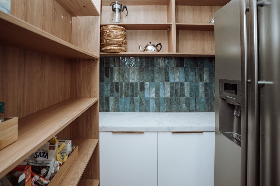 Walk in pantry and double door fridge. 