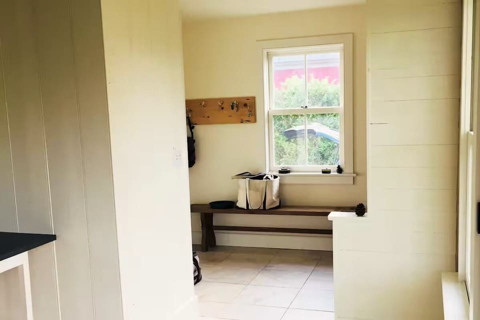 Mudroom has radiant heat floor and plenty of hooks for gear