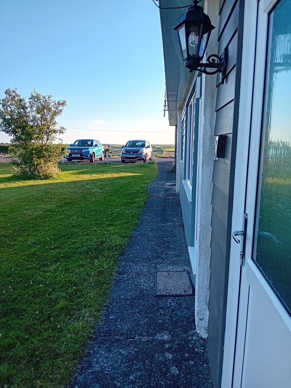 Our chalet with the wall lamp, distance to where the parking space is (blue car)