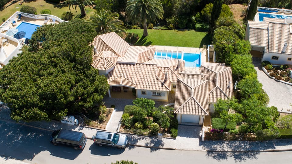 Front of villa with private garage and street parking