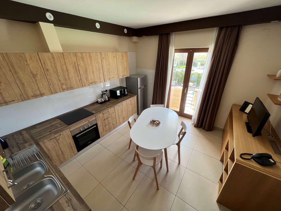 Suite, 1 Queen Bed, Balcony, Pool View (with Sofabed) | Private kitchen | Coffee/tea maker, full-size fridge, microwave, oven