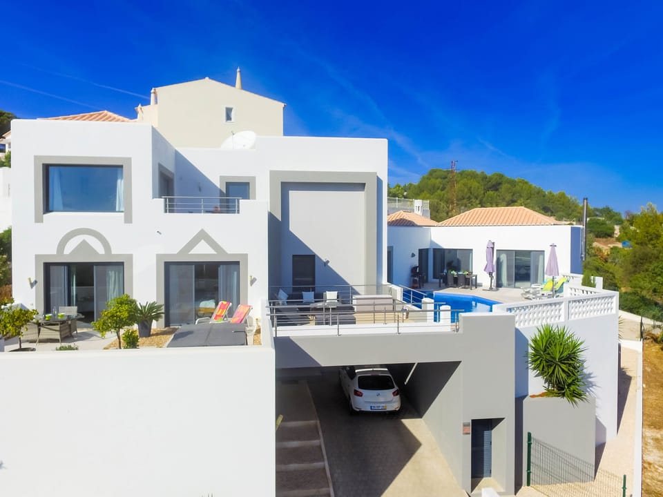 Bedrooms to the left, terrace over the drive and social/pool area to the right.