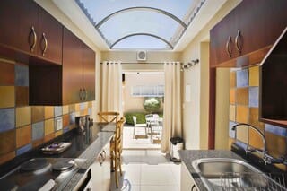 Junior Suite | Private kitchen | Full-size fridge, microwave, oven, stovetop
