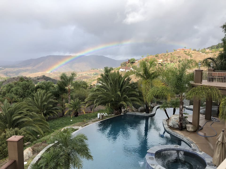 Tranquil and private salt water pool framed by a Fallbrook Rainbow