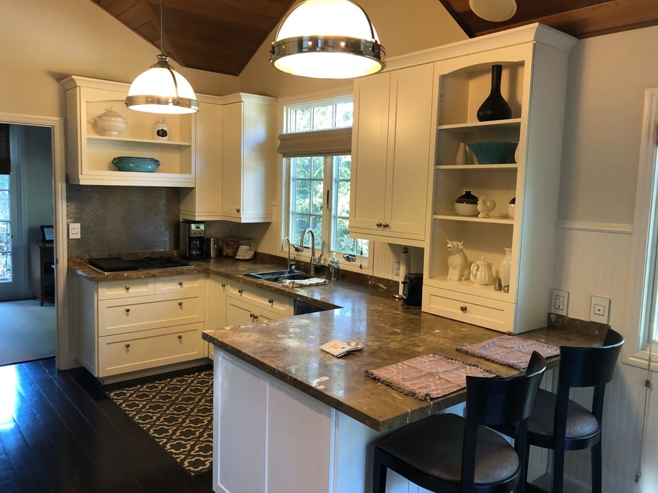 Full kitchen with refrigerator, oven, stovetop, coffee maker, and water chiller